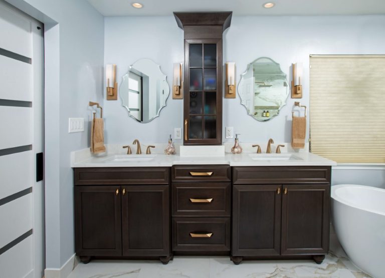 Modern bathroom with dark wood double vanity, dual sinks, mirrors, and white subway tile backsplash